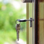 house key inserted in the front door - featured image