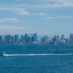 Stunning view of San Diego skyline and waterfront with boats under a clear blue sky.